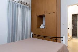 A bed or beds in a room at Stamatina House