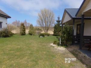 a yard next to a house at Villa Iwona in Grzybowo