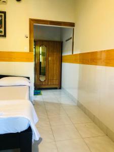 a hospital room with two beds and a door at Hoang Nga Garden Guesthouse in Mui Ne