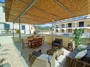 an outdoor patio with a table and chairs at Il PolpoLeo in Porto Azzurro Isola d'Elba in Porto Azzurro