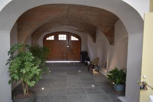 an entrance to a building with a large wooden door at Schloss Apartments in Braşov +34 photos