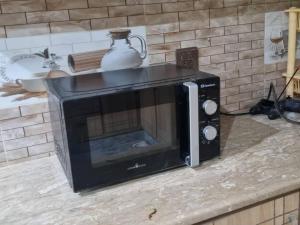 a microwave sitting on top of a counter at Gujar Khan - 3 Bed Apartment - sleeps 6 - Parking in Gūjar Khān