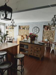 a room with tables and stools and a table and chairs at Casa castro in Cruces