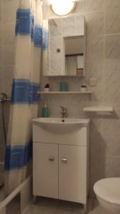 a bathroom with a sink and a toilet and a mirror at Guesthouse Podaca in Podaca +100 photos