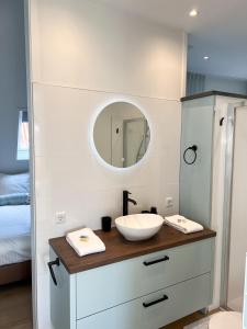 a bathroom with a sink and a mirror at Schitterend appartement HartVanDomburg in Domburg