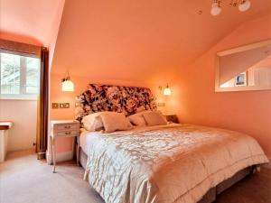 a bedroom with a large bed and a large window at Villa Rothsay Hotel in Cowes