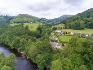 an aerial view of a village in the hills next to a river at Riverside Cottage in Llangollen