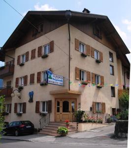 a building with a sign on the front of it at Albergo Genzianella in Fiavè