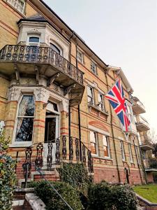 a large building with a flag on top of it at Villa Rothsay Hotel in Cowes
