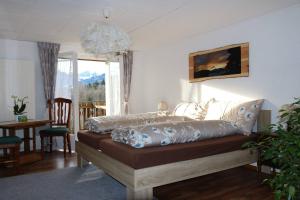 a bedroom with a bed and a dining room with a table at Schlafen im Sternen Ennetbühl in Nesslau