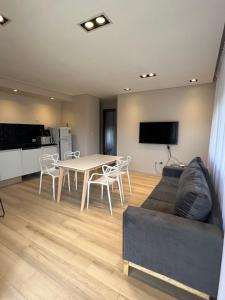a living room with a couch and a table at Tres Vientos - Lofts de Montaña Raco in Raco
