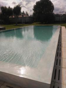 a large swimming pool with blue and green water at La Posada Multiespacios in Dique Luján