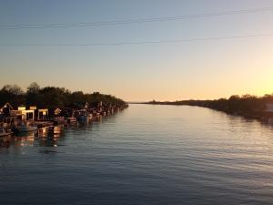a river with a bunch of boats in the water at House ThoNi in Gornji Štoj