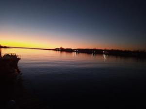 a large body of water with a sunset in the background at House ThoNi in Gornji Štoj