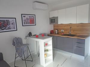 a kitchen with a counter and a sink and a table at Holiday Home Gordana in Hvar