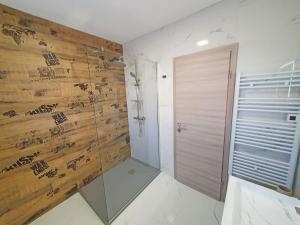 a bathroom with a shower and a wooden wall at Holiday Home Gordana in Hvar