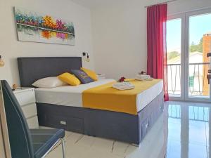 a bedroom with a bed and a chair in it at Holiday Home Gordana in Hvar