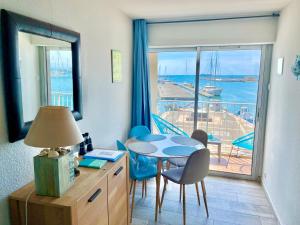 a room with a desk and a table and a window at LE PANORAMIQUE cap d’agde in Cap d'Agde