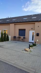 a house with a patio in front of it at LTM apartman in Spišská Nová Ves