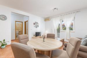 a living room with a wooden table and chairs at Cozy little place in amazing Istria in Peroj