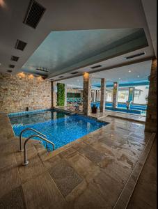 a large swimming pool in a building at Family Hotel Ognyanovo in Ognyanovo