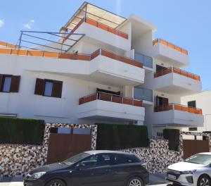 a building with cars parked in front of it at Pau-pi in Oliva