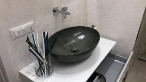 a green bowl sitting on a counter in a bathroom at Casa Chartù -luxury house- in Conversano