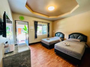Postel nebo postele na pokoji v ubytování Benwadee Resort Pattaya