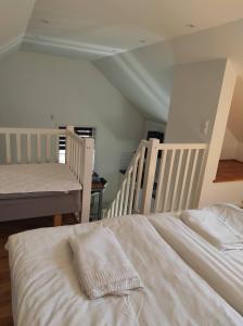 a bedroom with two beds with white sheets at Villa Wettervy in Gränna