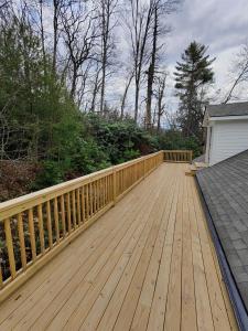 a wooden deck with a fence on a house at Highlands at it's best in Highlands