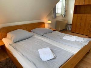 a bedroom with two beds with white towels on them at Haus am Kurhaus 9 in Nordstrand