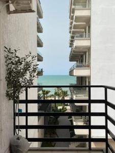 a balcony with a view of the ocean from a building at Mineu Vacation Rentals in Golem