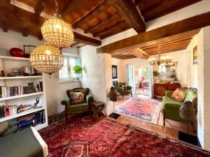 salon z 2 żyrandolami i salon z dywanem w obiekcie Magical villa, breathtaking views, large private garden and olive grove - in a cool village on the Umbria Tuscany Border w mieście Gioiella