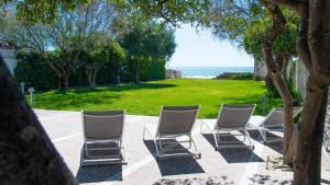 a row of chairs sitting on a patio at Villa degli Squali Suite Home in Terracina