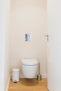 a bathroom with a white toilet in a room at Regina's Banyuls - Modern and brand new apartment in Banyuls-sur-Mer