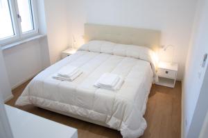 Postel nebo postele na pokoji v ubytování Villa degli Squali Suite Home