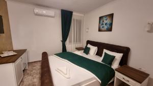 Ένα ή περισσότερα κρεβάτια σε δωμάτιο στο Vila Bun