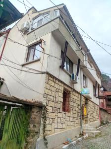an old stone building with a window on it at Guest House Perla in Bachkovo
