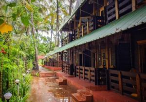 a building in the middle of a forest at Lotus Feet Cottages, 100 Odd Meters from Morjim Beach in Morjim