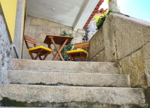 a set of stairs with chairs and a table at Casa Beira Rio in Viana do Castelo