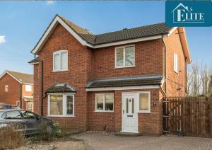 a brick house with a car parked in front of it at House with Garden & Private Driveway - Elite Properties in Leamington Spa