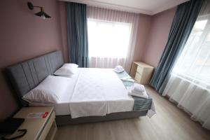 a small bedroom with a bed and a window at Stay Inn Edirne in Edirne