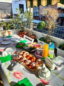 a table with food on top of a balcony at La Castellese in Aci Castello
