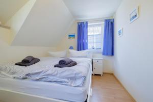 a bedroom with a bed with towels on it at Haus Möwe in Zingst
