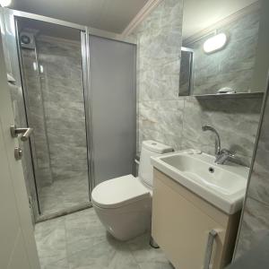 a bathroom with a toilet and a sink and a shower at Stay Inn Edirne in Edirne