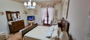 a bedroom with a bed and a television in it at La stanza della nonna in Modica