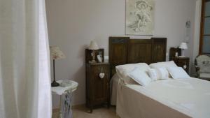 a bedroom with a bed with white sheets and white pillows at La stanza della nonna in Modica