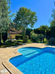 a swimming pool in a yard with a tree at Hotel Aatu - Adults Only in Peratallada