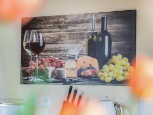 a painting of wine and cheese and wine glasses at Speicher Hafendomizil in Barth