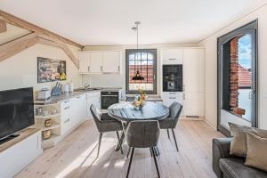 a kitchen and dining room with a table and chairs at Speicher Hafendomizil in Barth